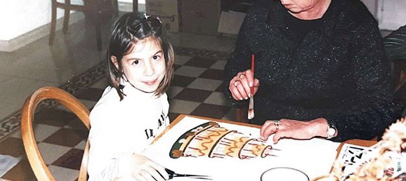 Letizia as a child, drawing at the kitchen table